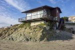 This iconic oceanfront cayucos beach home sits directly over the sand offering direct beach access and stunning views